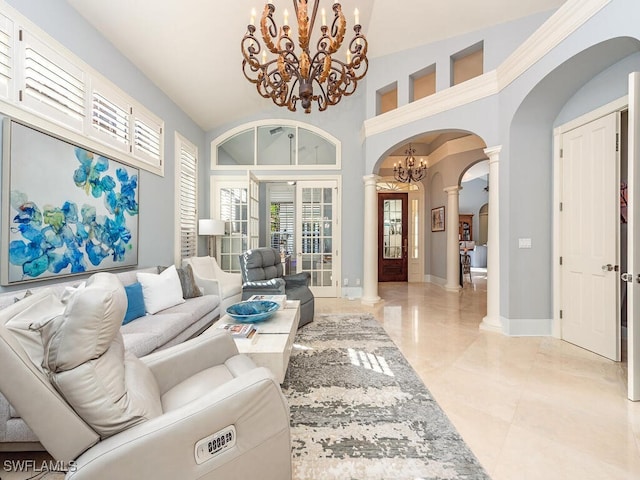 living room featuring ornate columns, french doors, high vaulted ceiling, and an inviting chandelier