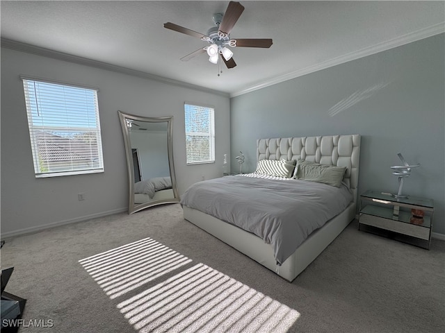 bedroom with ceiling fan, ornamental molding, and light carpet