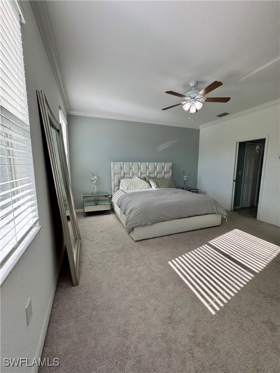 carpeted bedroom with a textured ceiling, ceiling fan, and crown molding