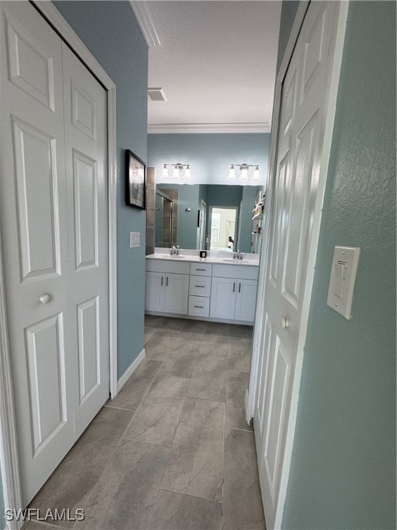 bathroom featuring vanity and ornamental molding