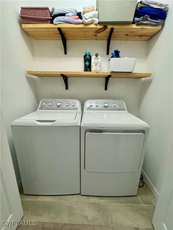 clothes washing area with washing machine and dryer