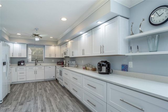 kitchen featuring white cabinetry, ceiling fan, crown molding, light hardwood / wood-style floors, and white appliances