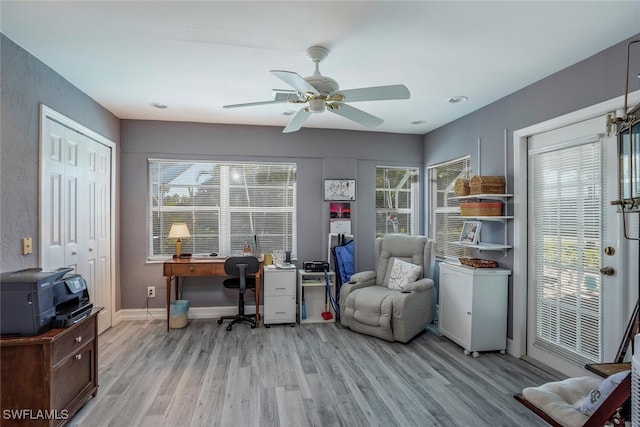 office space with light wood-type flooring and ceiling fan