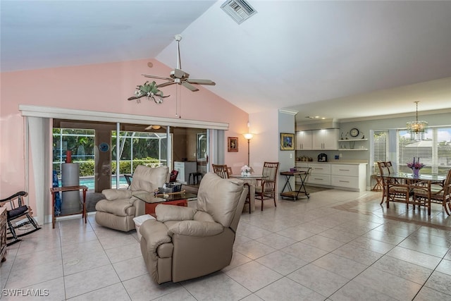 living room featuring light tile patterned floors, ceiling fan with notable chandelier, and high vaulted ceiling