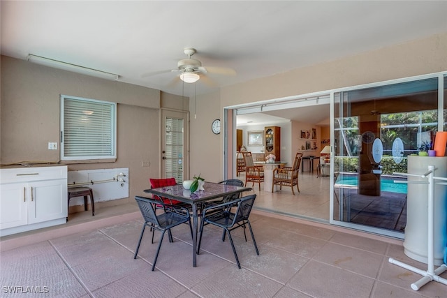 tiled dining area featuring ceiling fan