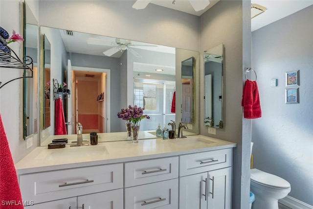 bathroom featuring ceiling fan, vanity, and toilet