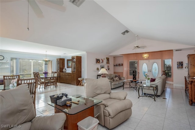 living room featuring ceiling fan, lofted ceiling, and light tile patterned floors