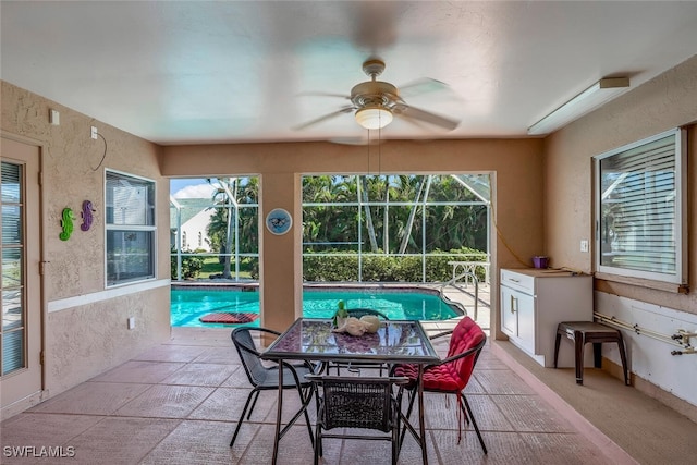 sunroom with a wealth of natural light and ceiling fan