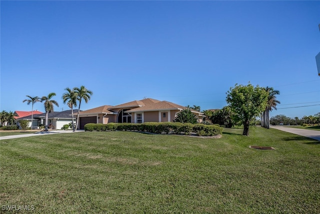 ranch-style home with a front lawn and a garage