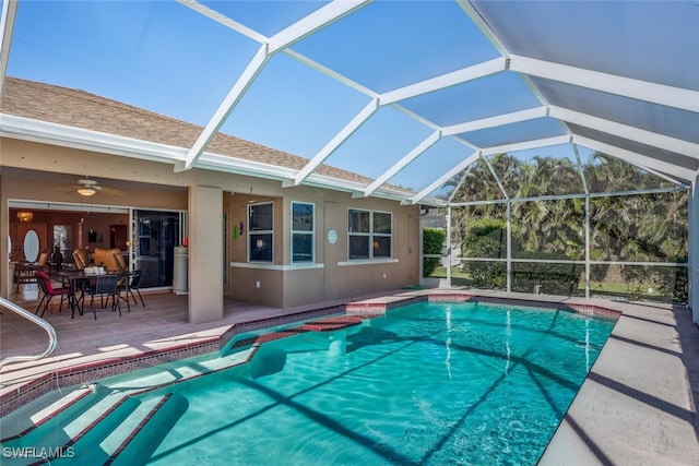 view of pool featuring ceiling fan, a patio, and glass enclosure