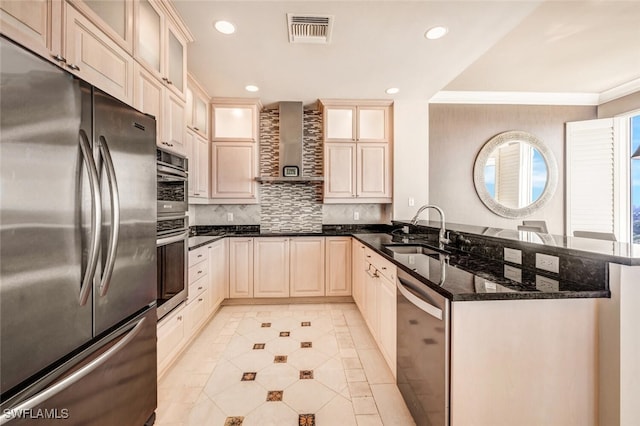 kitchen with backsplash, wall chimney exhaust hood, stainless steel appliances, sink, and dark stone countertops