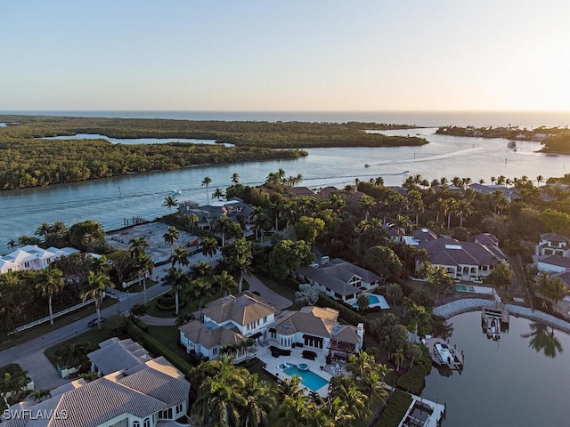 aerial view at dusk with a water view