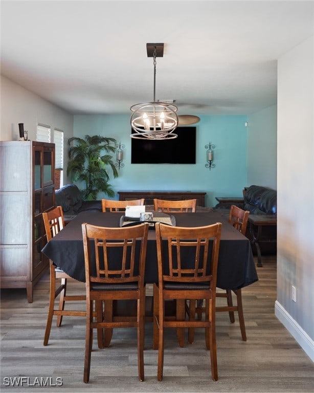 dining room with a notable chandelier and wood-type flooring