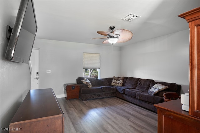 living room featuring ceiling fan and dark hardwood / wood-style flooring