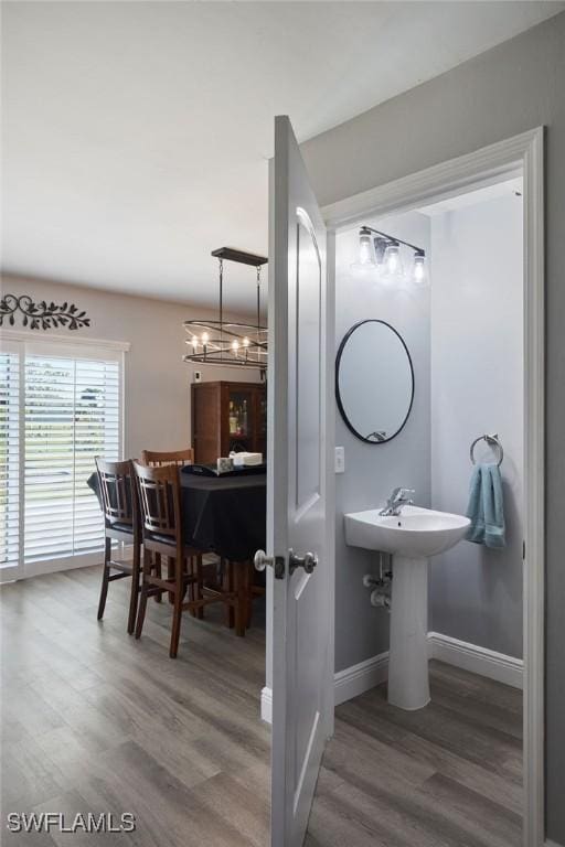 3507 SW 15th Ave, Cape Coral, FL 33914 - bathroom featuring wood finished floors and a chandelier
