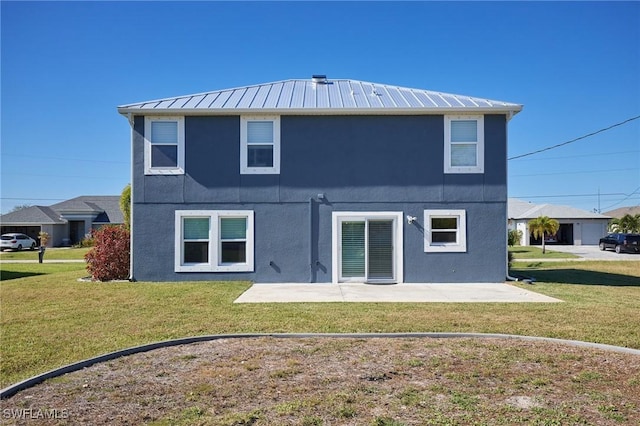3507 SW 15th Ave, Cape Coral, FL 33914 - back of house featuring stucco siding, a patio area, a yard, a metal roof, and a standing seam roof