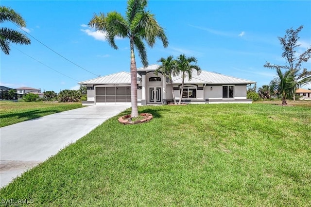 view of front of home featuring a front lawn and a garage