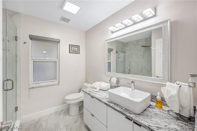 bathroom with vanity, toilet, and a shower with shower door