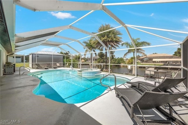 view of pool featuring an in ground hot tub, a patio, a water view, and a lanai