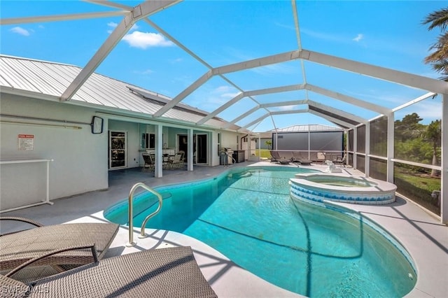 view of swimming pool featuring a patio area, an in ground hot tub, and glass enclosure