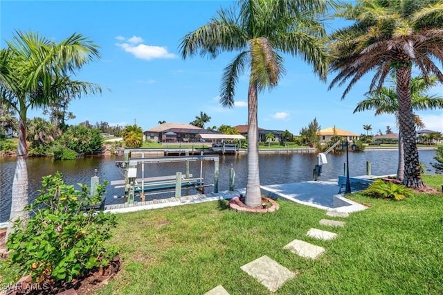 view of dock with a water view and a lawn