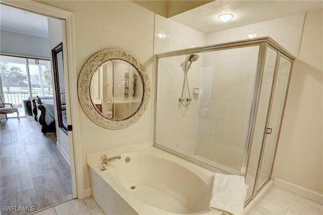 bathroom with plus walk in shower and wood-type flooring