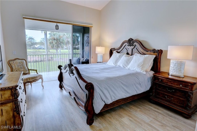 486 Edgemere Way E Unit 2-3, Naples, FL 34105 - bedroom with wood finished floors and access to outside