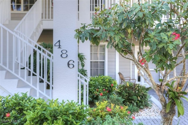 486 Edgemere Way E Unit 2-3, Naples, FL 34105 - exterior view of stucco siding and stairs