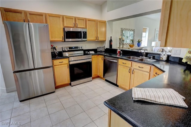 kitchen with kitchen peninsula, sink, light tile patterned flooring, and stainless steel appliances