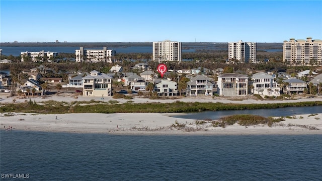 drone / aerial view featuring a view of the beach and a water view