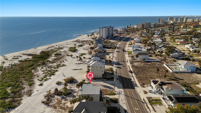 bird's eye view featuring a water view and a beach view