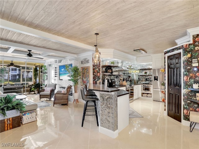 kitchen featuring white cabinetry, hanging light fixtures, a breakfast bar, wood ceiling, and appliances with stainless steel finishes