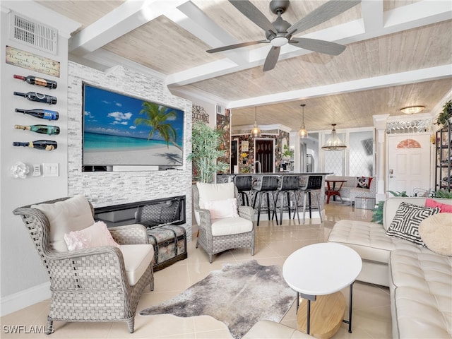 tiled living room featuring beam ceiling, ceiling fan with notable chandelier, and wood ceiling