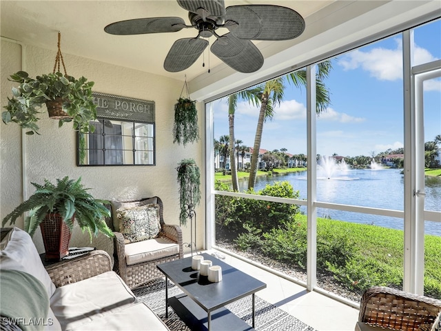 sunroom / solarium with ceiling fan and a water view