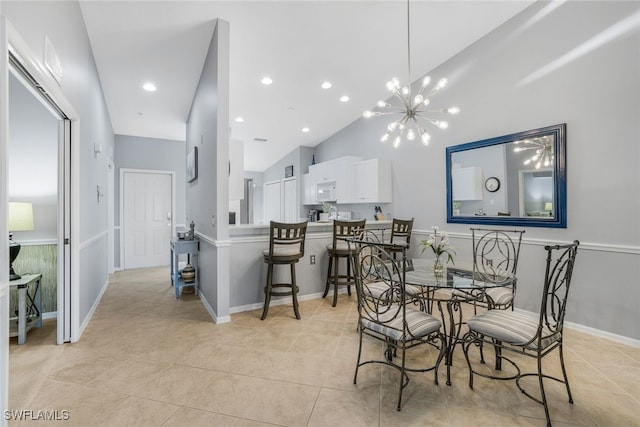 tiled dining space with high vaulted ceiling and an inviting chandelier