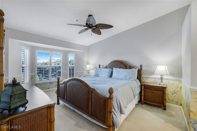 bedroom with light colored carpet, ceiling fan, and lofted ceiling