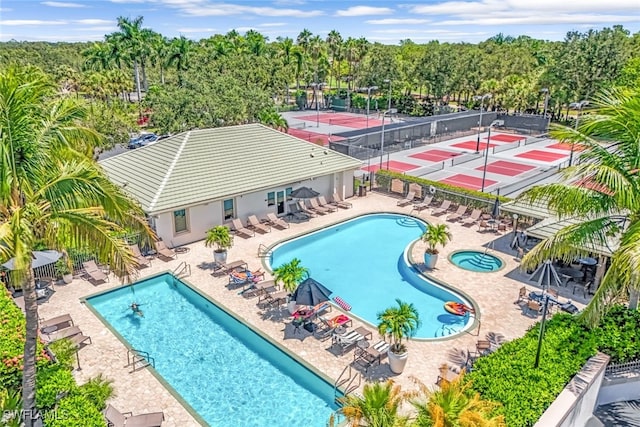 view of pool with tennis court