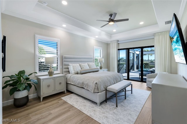 bedroom with light wood-type flooring, access to outside, and multiple windows