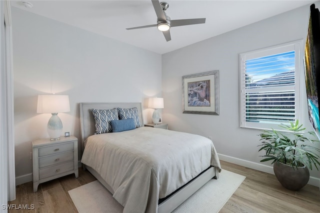 bedroom with ceiling fan and light wood-type flooring