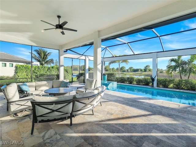 view of pool featuring outdoor lounge area, a lanai, ceiling fan, and a patio area