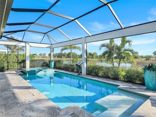 view of swimming pool featuring glass enclosure, a patio area, and a water view