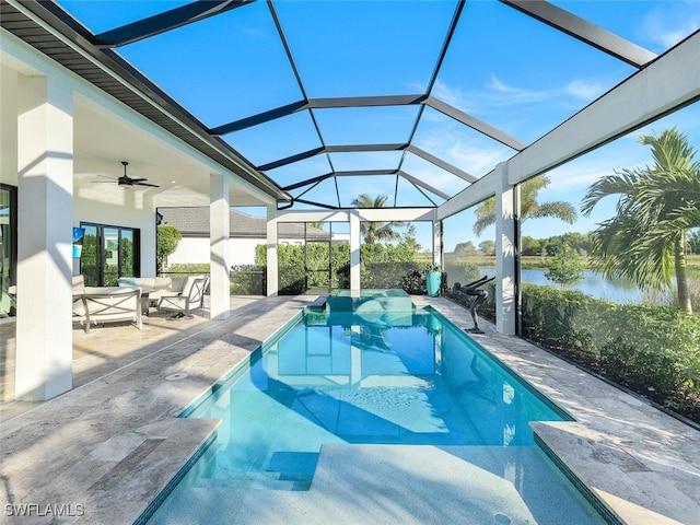 view of pool with a patio area, ceiling fan, glass enclosure, and an outdoor hangout area