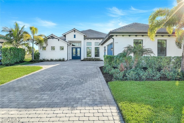 view of front of home featuring a front yard and french doors