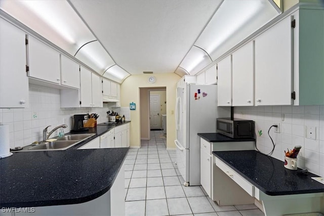 kitchen featuring white cabinets, light tile patterned floors, sink, and tasteful backsplash