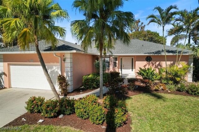 single story home featuring a front lawn and a garage