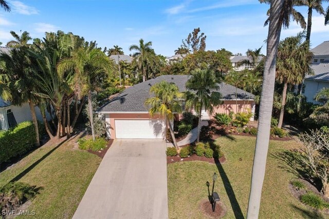 view of front of home with a garage and a front yard