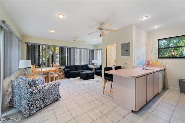 kitchen featuring ceiling fan, sink, kitchen peninsula, electric panel, and light tile patterned floors