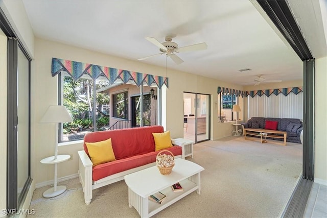 living room featuring ceiling fan and carpet