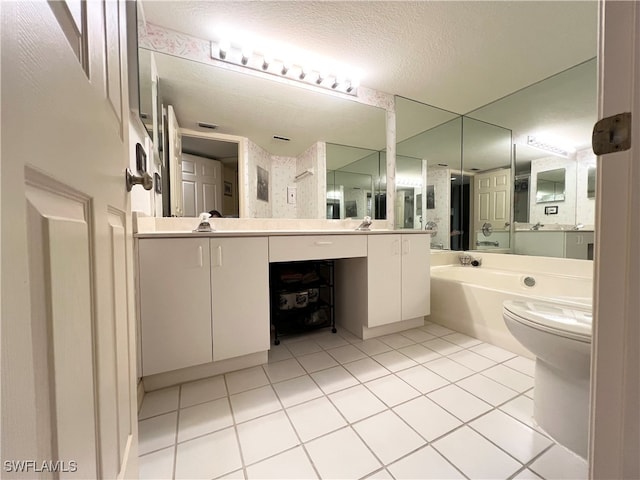 bathroom with tile patterned floors, a bathing tub, a textured ceiling, and toilet