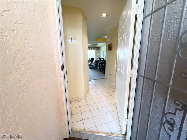 corridor featuring light tile patterned flooring